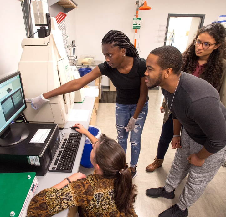 Student and faculty member looking at a computer